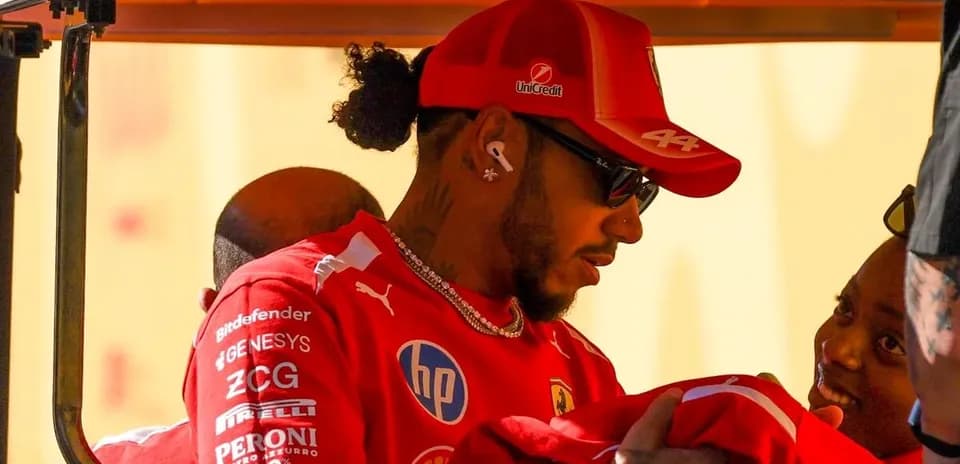 Piloto de Fórmula 1 en uniforme Ferrari interactuando