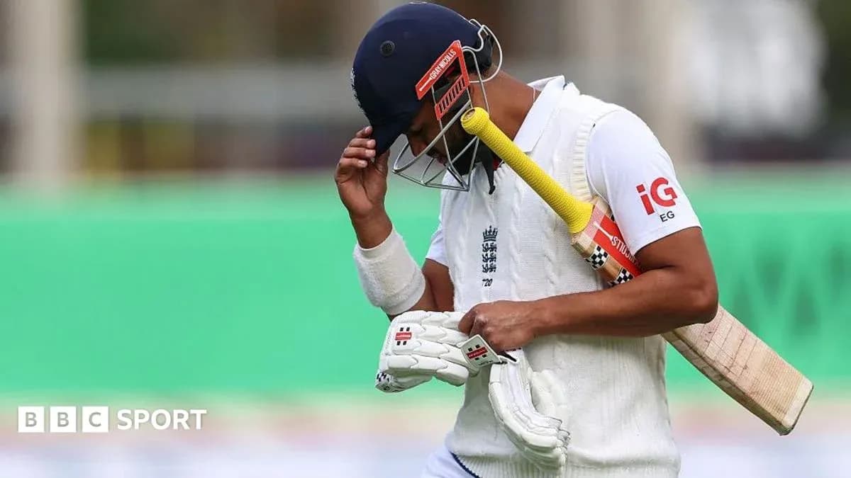 Jugador de cricket caminando cabizbajo con bate