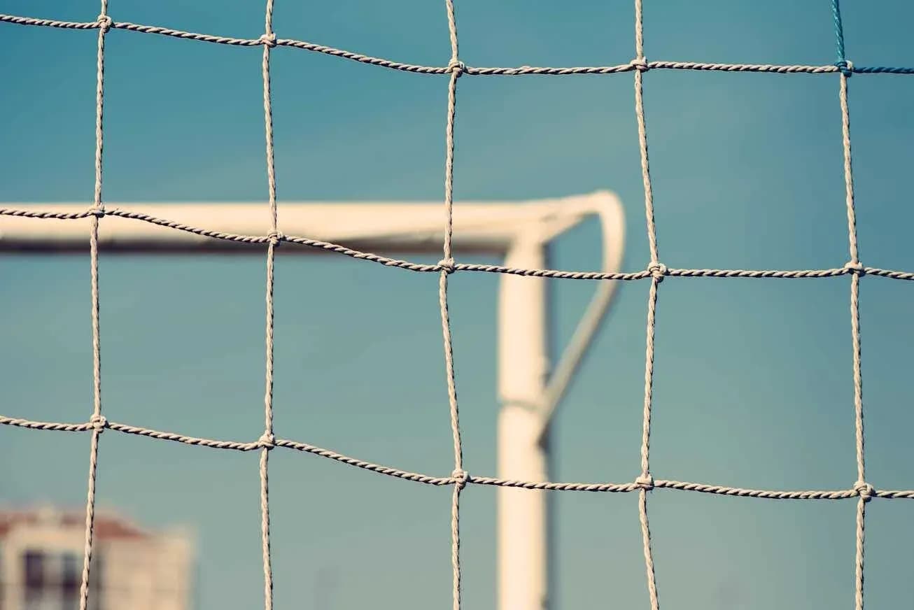 Red de una portería de fútbol contra un cielo azul