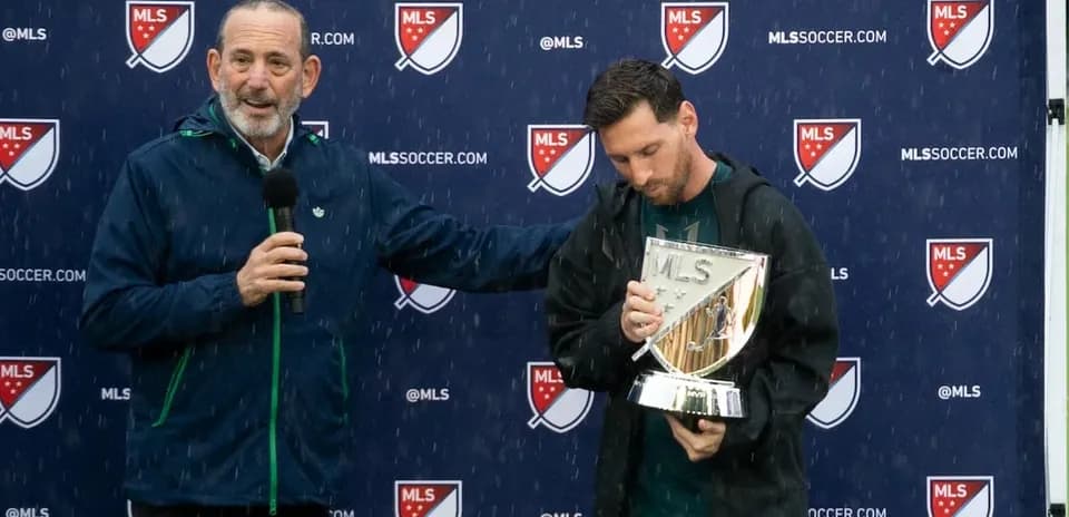 Lionel Messi holding MLS trophy during presentation ceremony