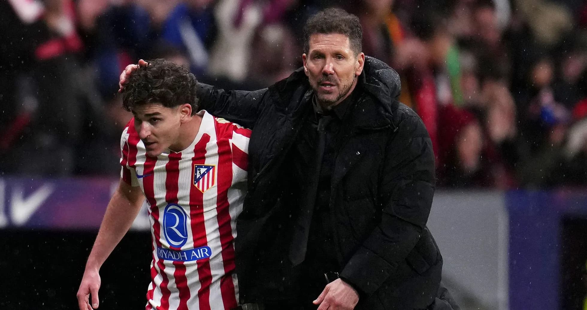 Entrenador apoyando a jugador durante el partido