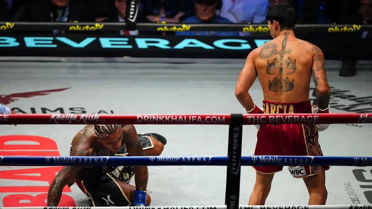 Boxeador en el suelo y otro de pie en el ring