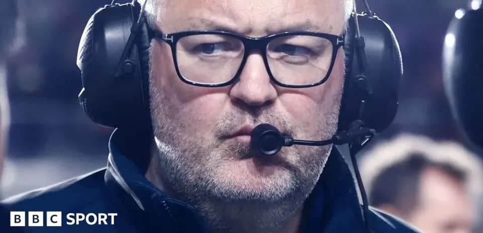 Hombre con auriculares en el banquillo durante el partido
