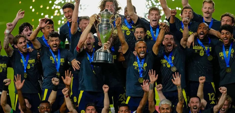 Equipo celebrando con trofeo tras ganar campeonato