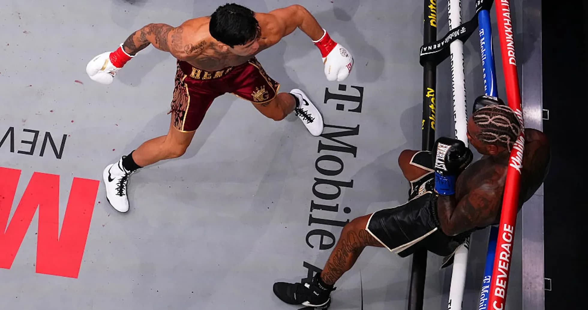 Boxer throwing punch at opponent in the ring