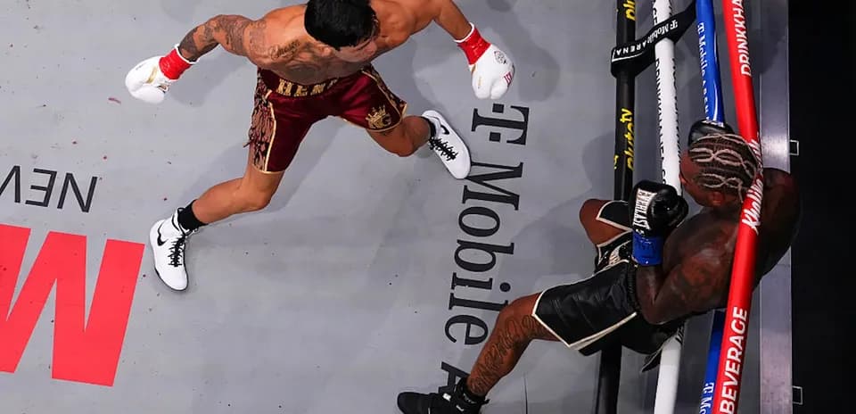 Boxer throwing punch at opponent in the ring