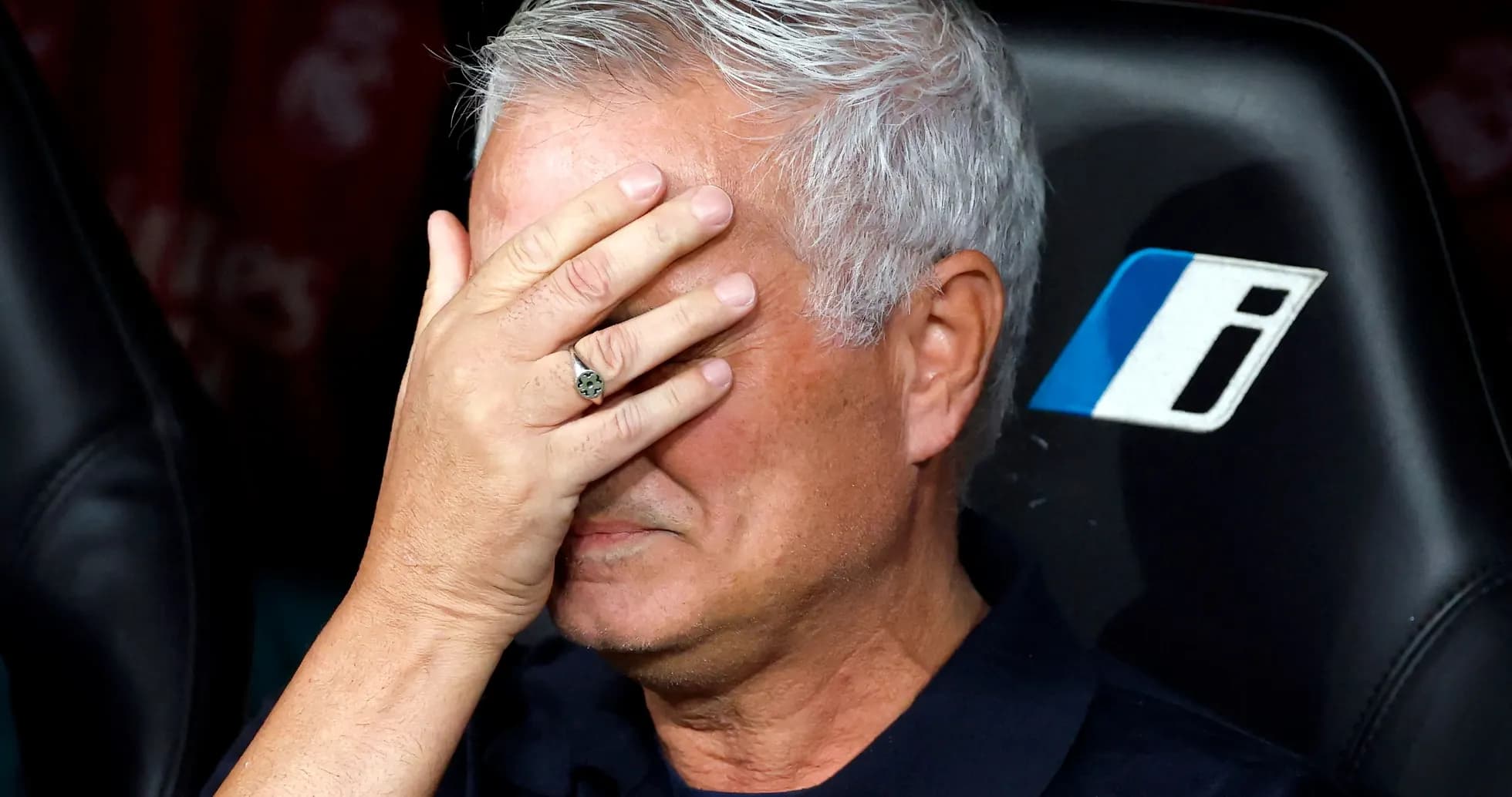 Entrenador cubriendo su rostro con la mano