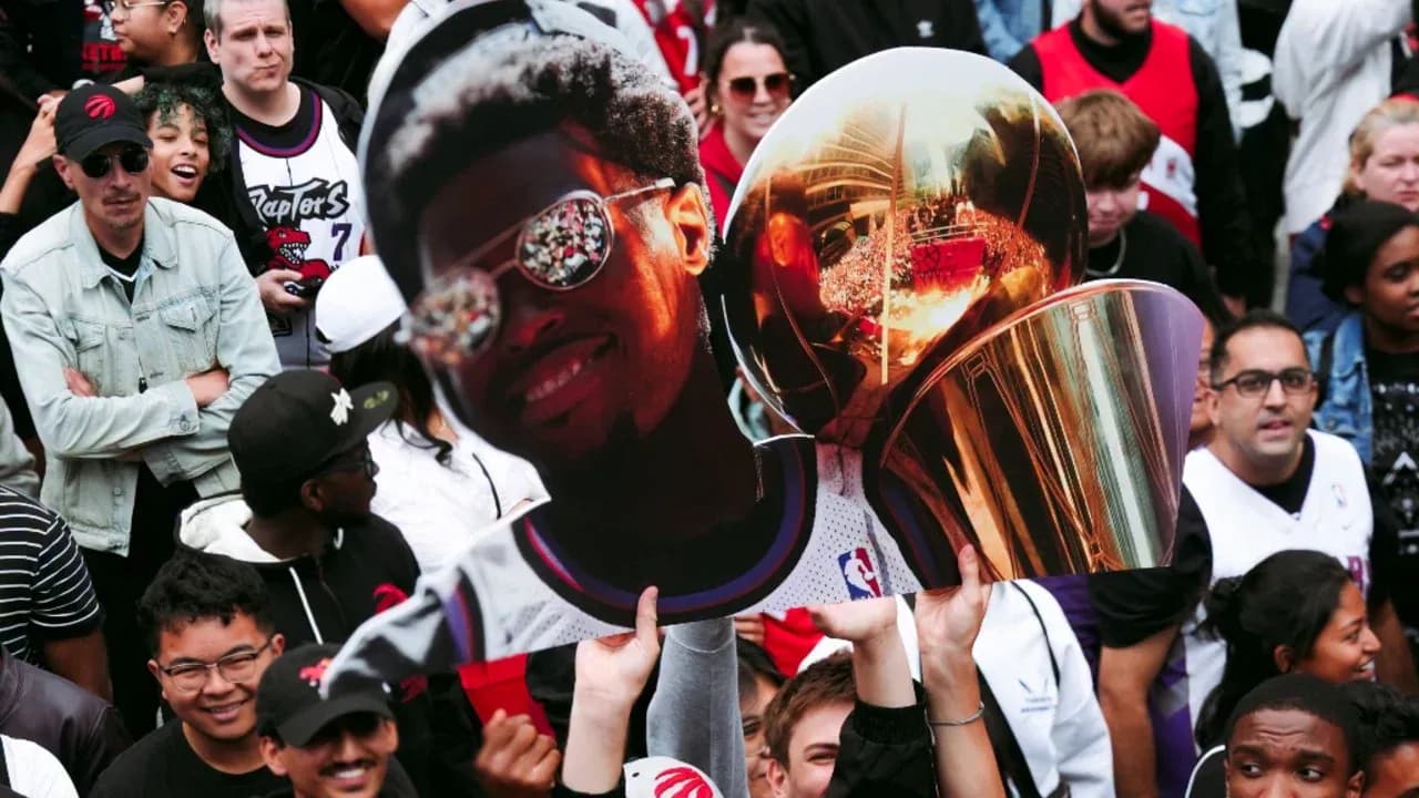 Fan holding a large cutout of a player and trophy Fan holding a large cutout of a player and trophy