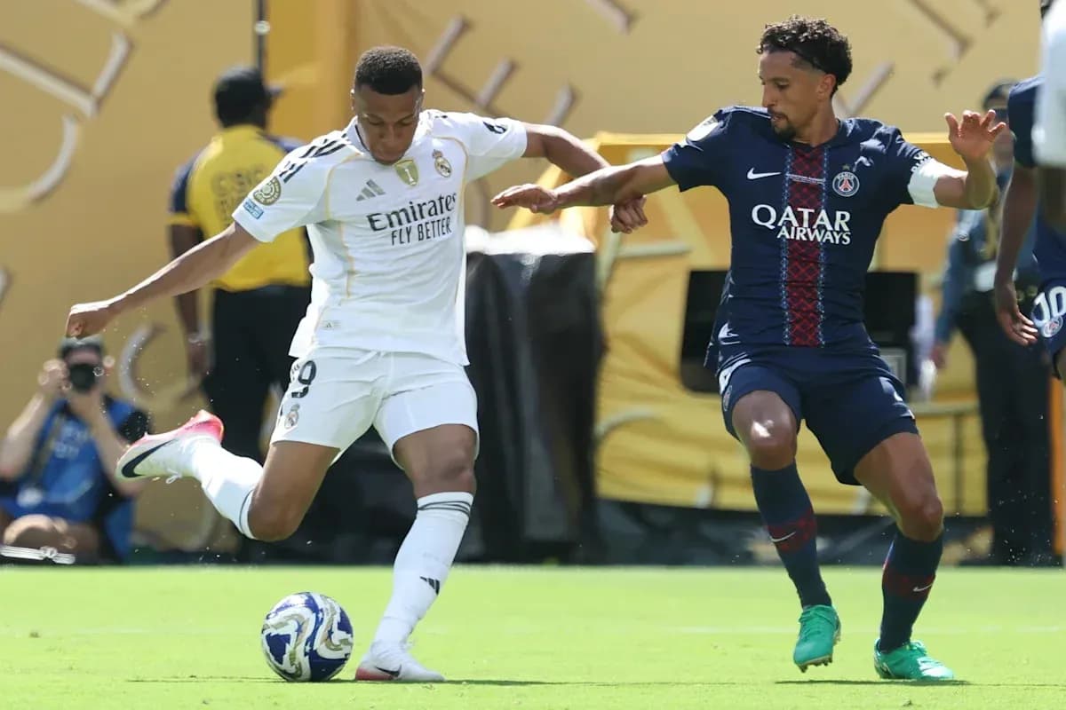 Jugador de Real Madrid driblando ante defensor de PSG Jugador de Real Madrid driblando ante defensor de PSG